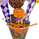 Close-up of the Halloween Parrot Treat Cup filled with shreddable paper and wooden pieces