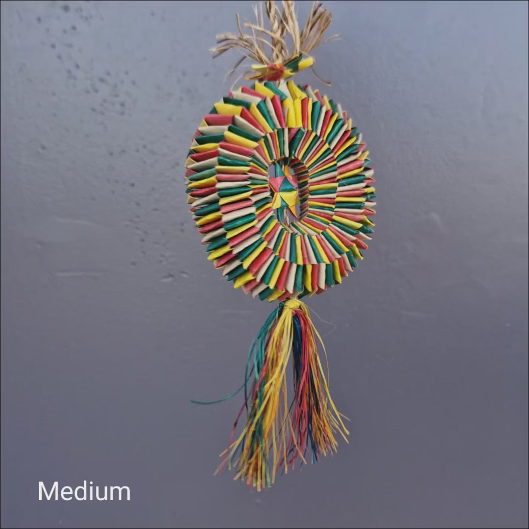 Piñata Foraging Wheel filled with colourful shreddable pieces for parrots to chew, pull apart and explore.