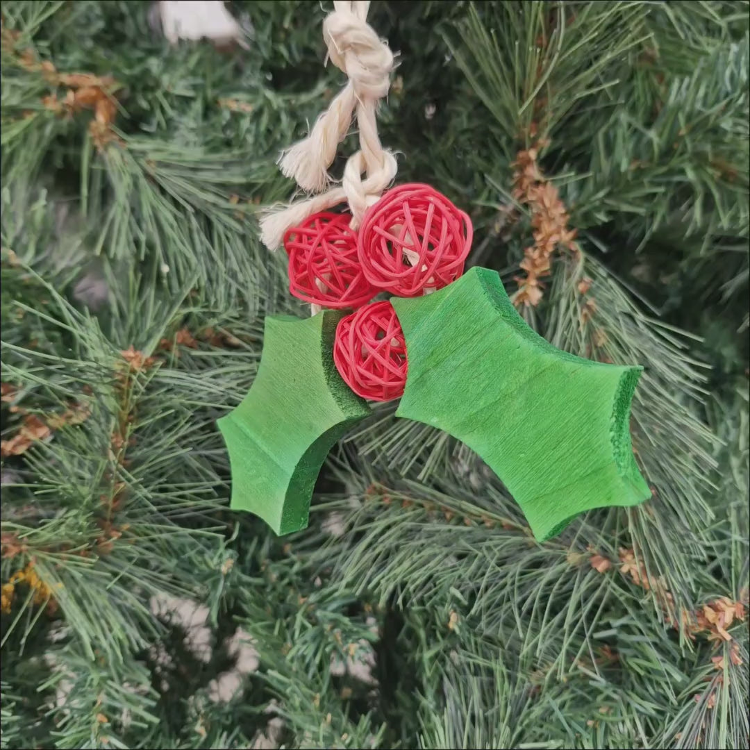 Video showing the Christmas Holly Chew, its green wooden holly leaves and red woven balls