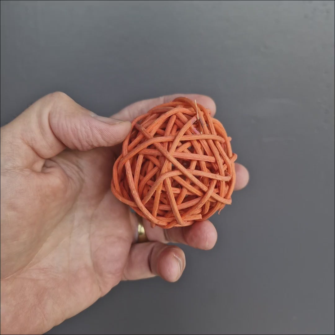 Colourful Wicker Ball Foot Toy showing the lightweight woven rattan design and open ball shape